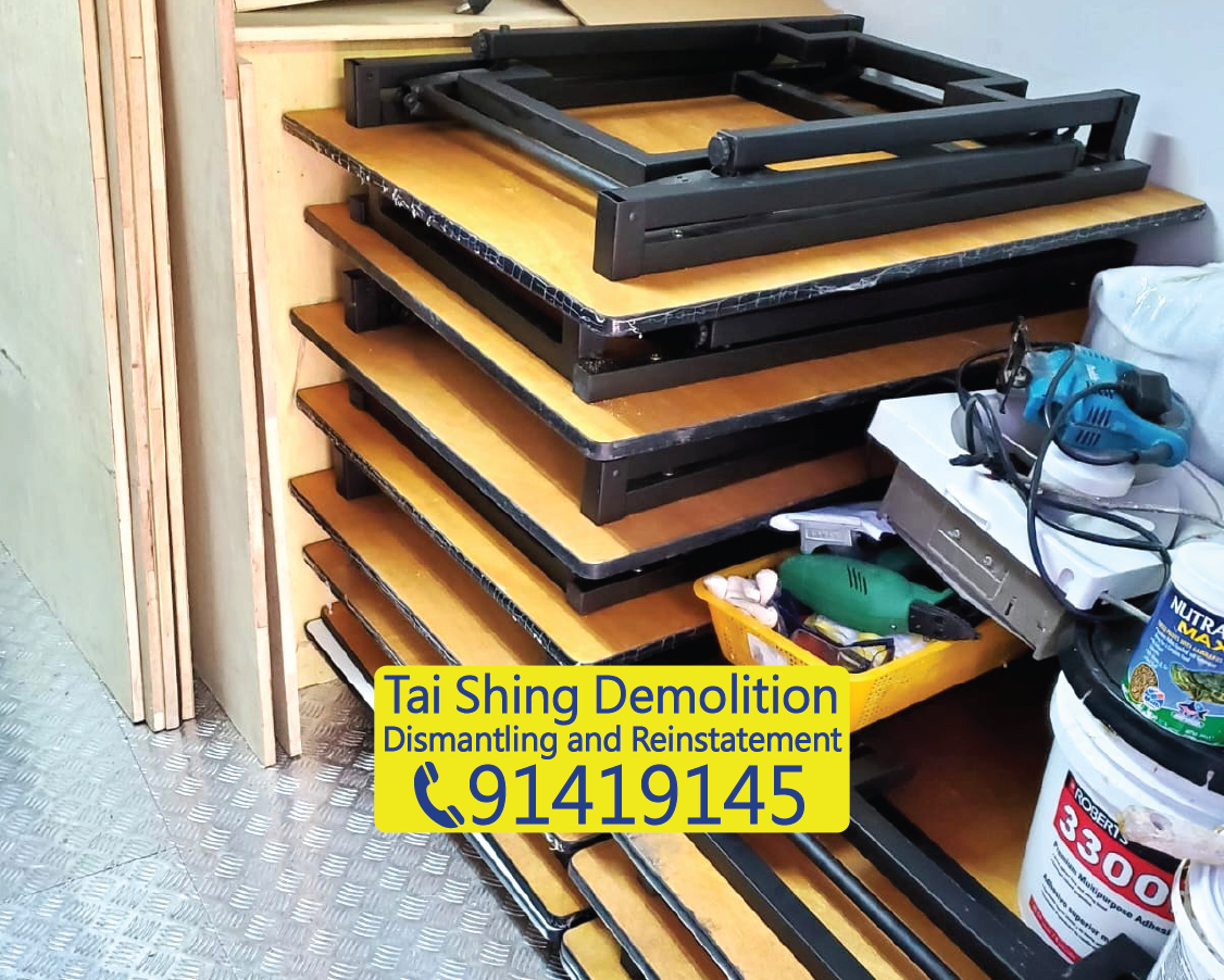 School classroom furniture dismantling, desk wooden boards and metal frames sorted for recycling, educational institution clearance and handover